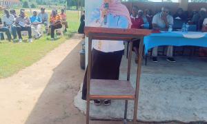 A KUCCPS officer addressing parents and students of Tiwi Girls Secondary School on 24/5/2025 during the school's AGM. Present were about 300 students, 250 parents alongside the institution's leadership and religious leaders.