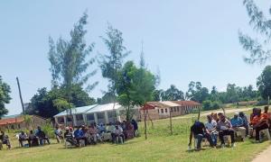 A KUCCPS officer addressing parents and students of Tiwi Girls Secondary School on 24/5/2025 during the school's AGM. Present were about 300 students, 250 parents alongside the institution's leadership and religious leaders.